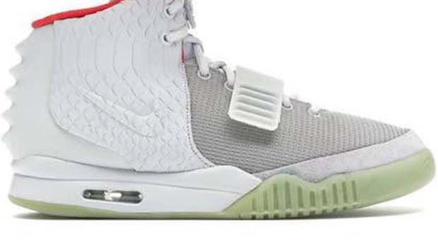 View of white, grey, and red Nike Air Yeezy 2 shoes.